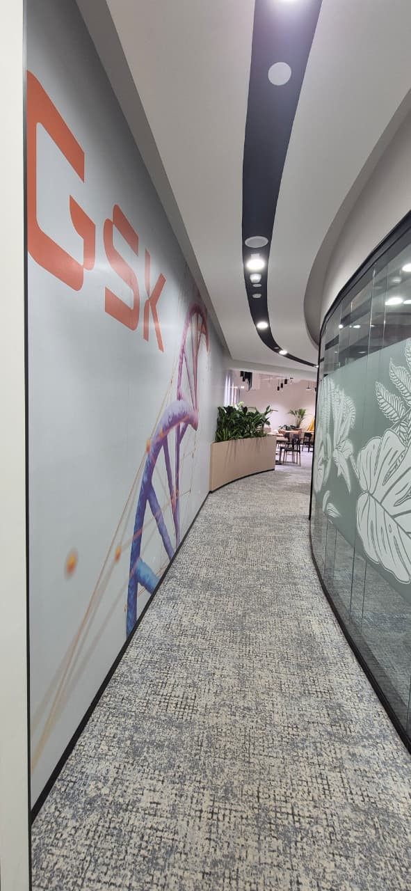 Vertical view of the GSK office breakout lounge with planted bench seating, Bengaluru
